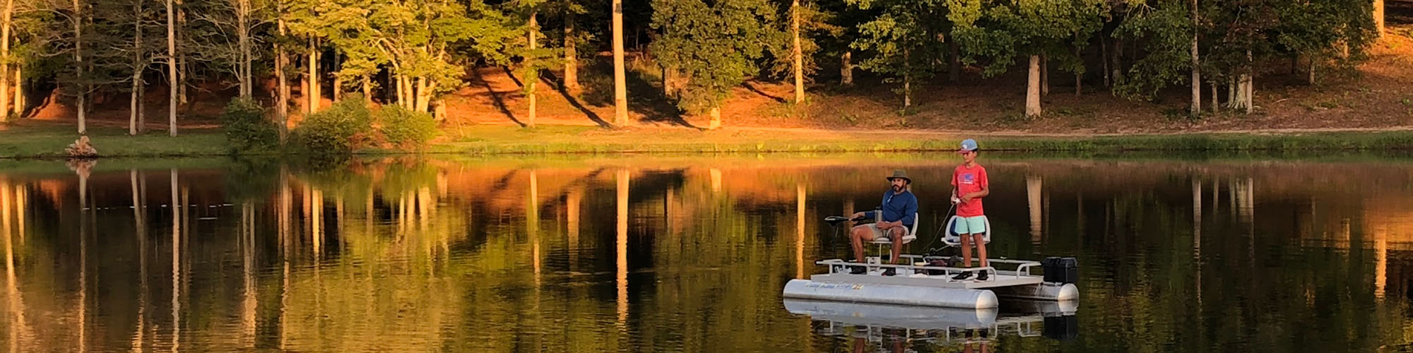 Dad and son fishing on boat in fall