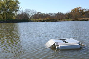A Set Pond King Floating Turtle Trap on a Pond
