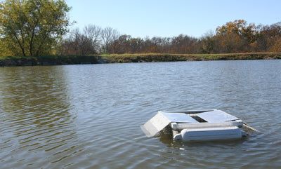 A Set Pond King Floating Turtle Trap on a Pond